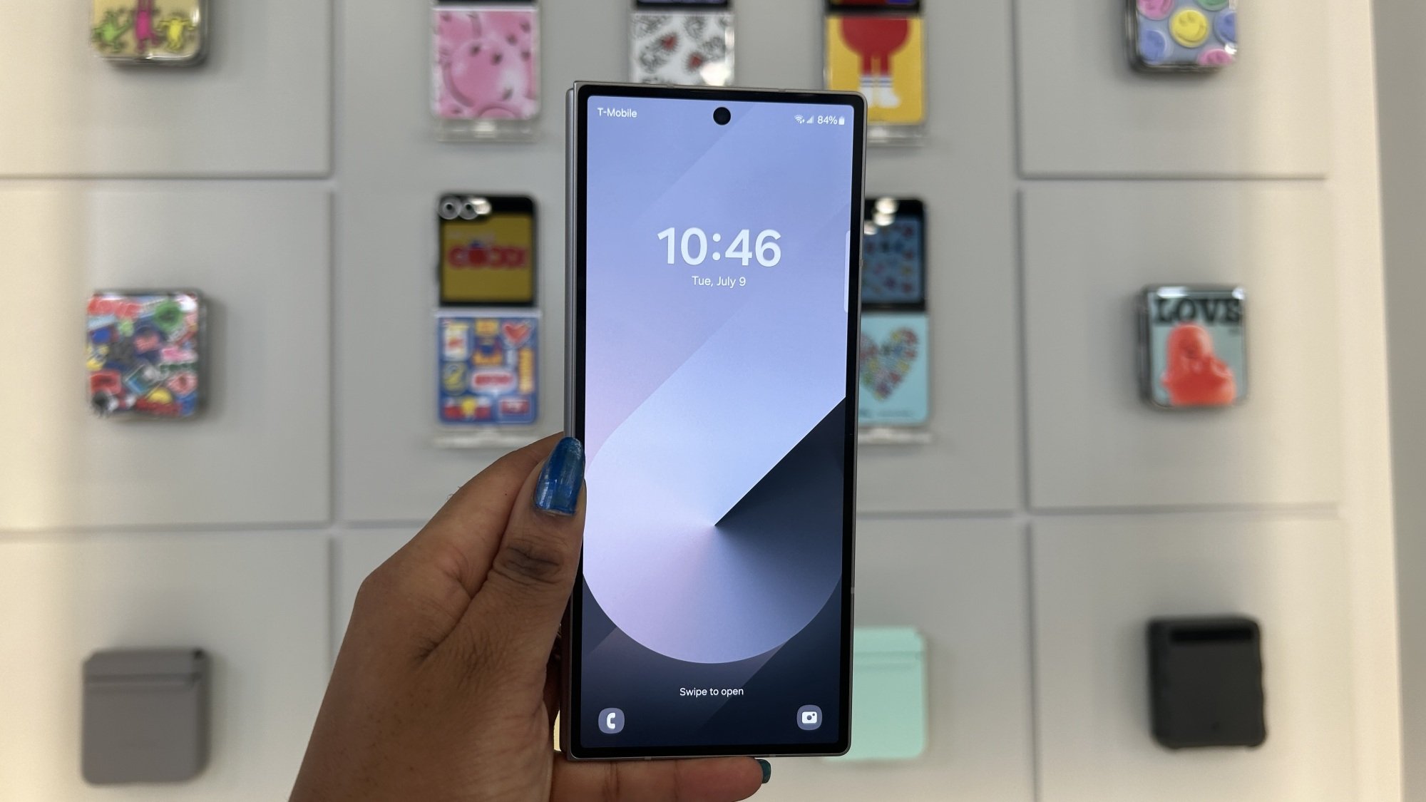 Hand holding Samsung Galaxy Z Fold 6 showcasing front display Lock Screen