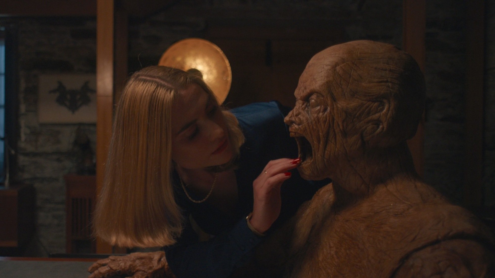 Yana (Caroline Menton) reaches into the Wooden Man's mouth in "Oddity."