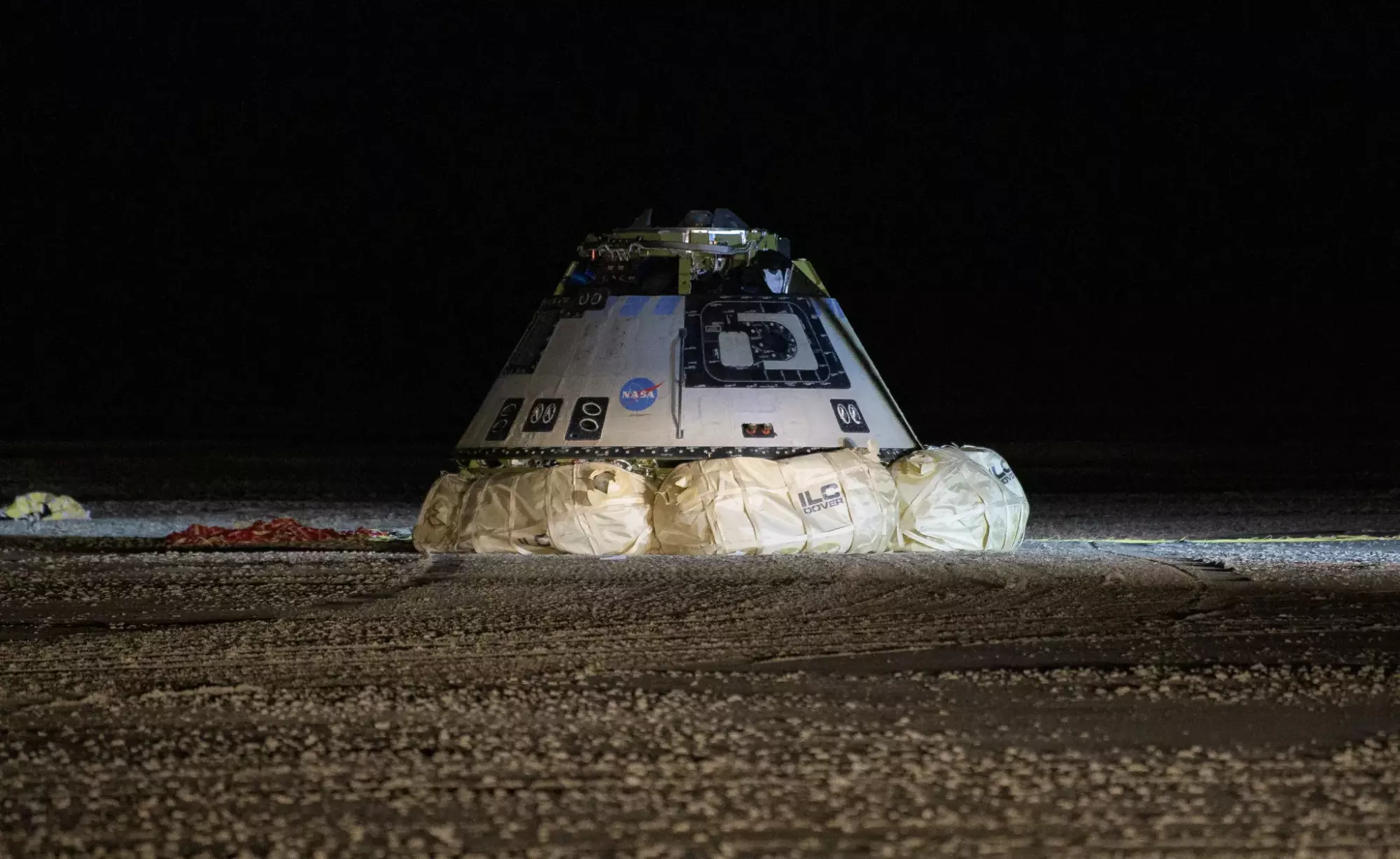 An empty Starliner landing in a New Mexico desert