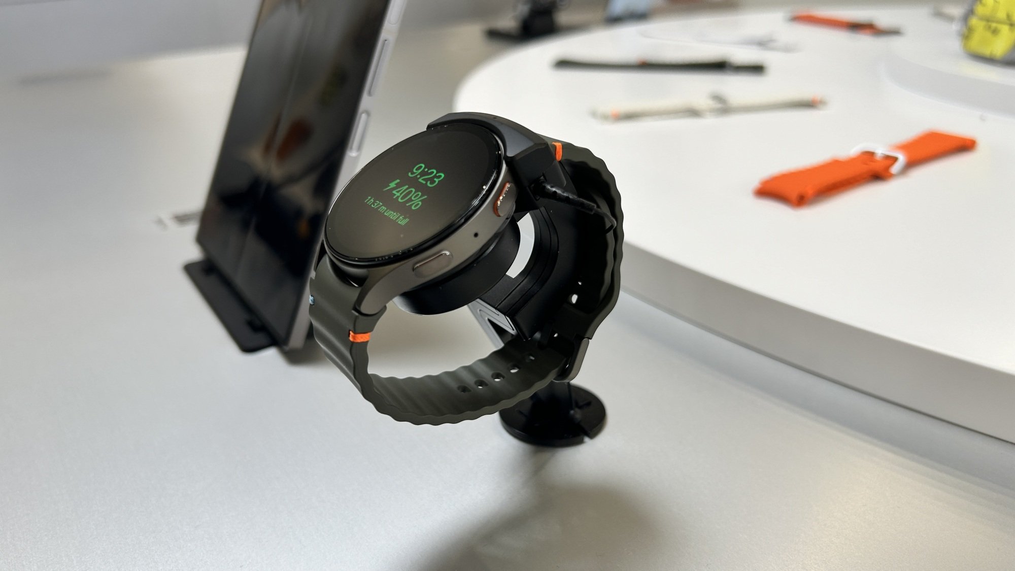 Samsung Galaxy Watch 7 with straps in the background