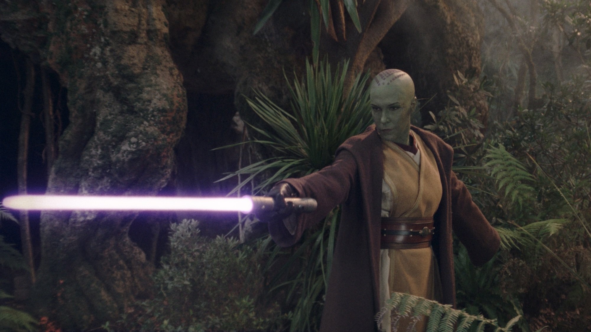 Vernestra Rwoh wields her purple lightsaber in the forests of Khofar.