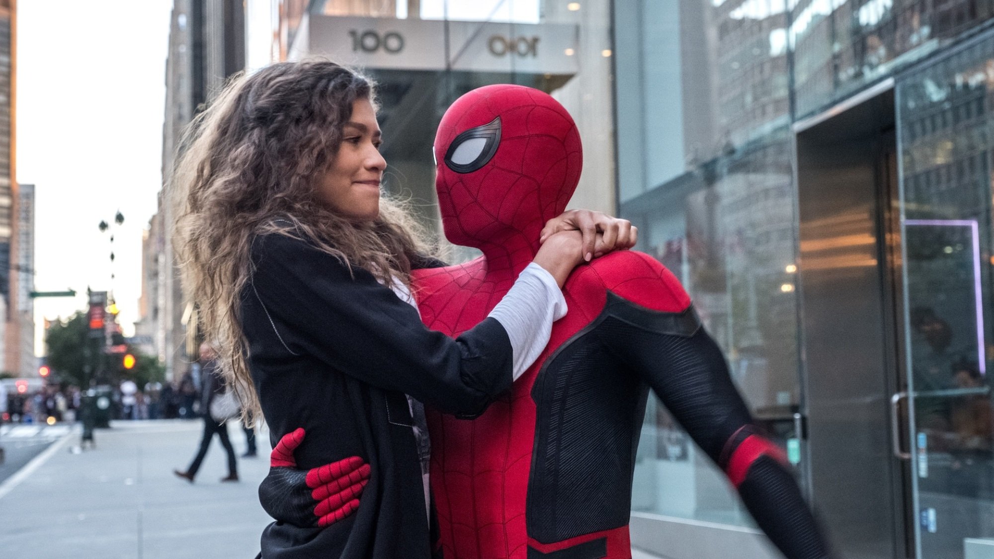 Spider-Man holding MJ (Zendaya) on the streets of New York City.