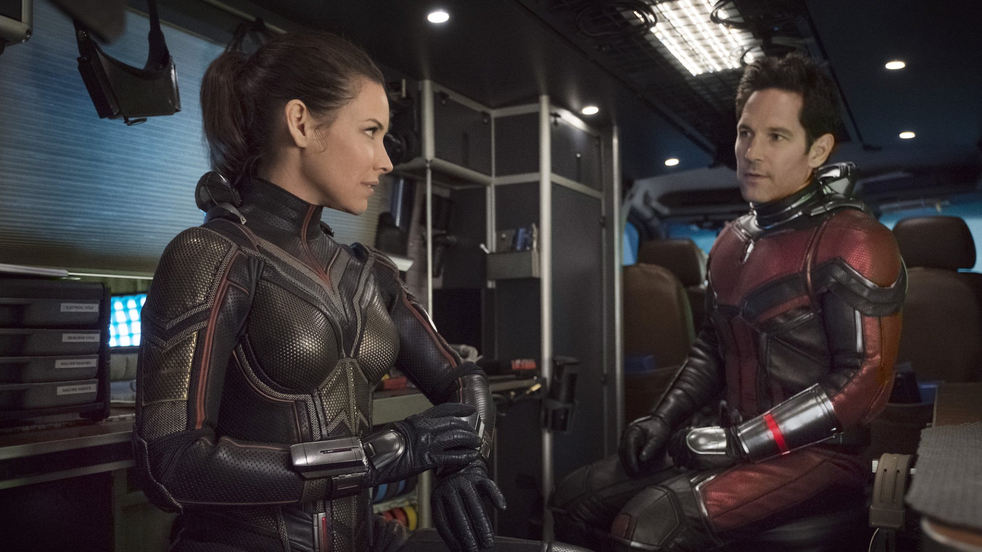 Hope (Evangeline Lilly) and Scott (Paul Rudd) talk while wearing futuristic metal armor.