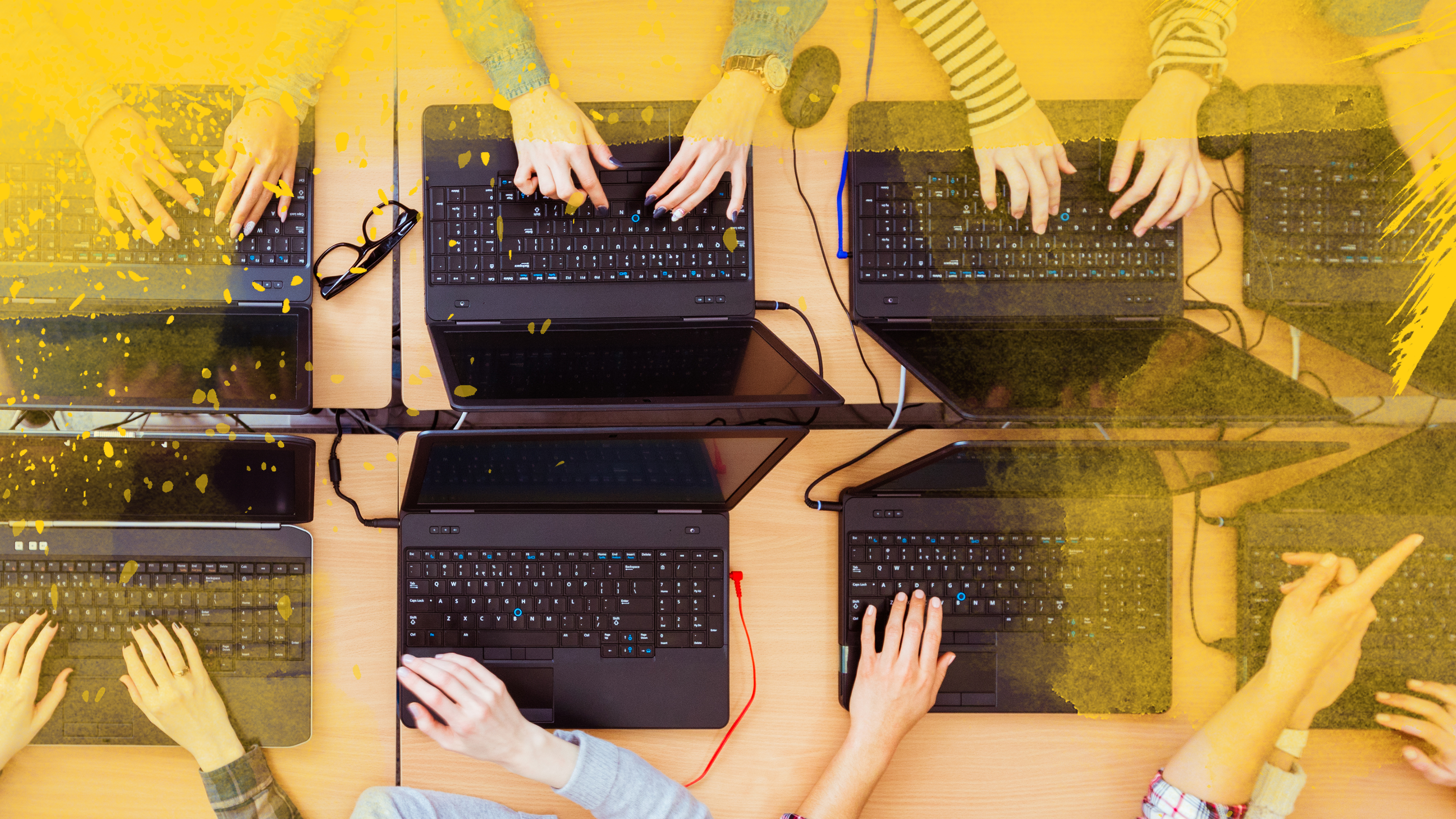 hands working on keyboards