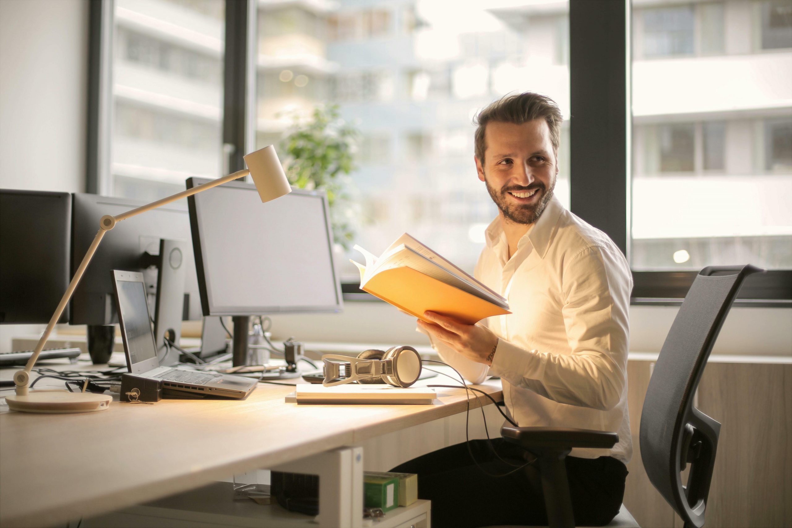 smiling man at his office desk