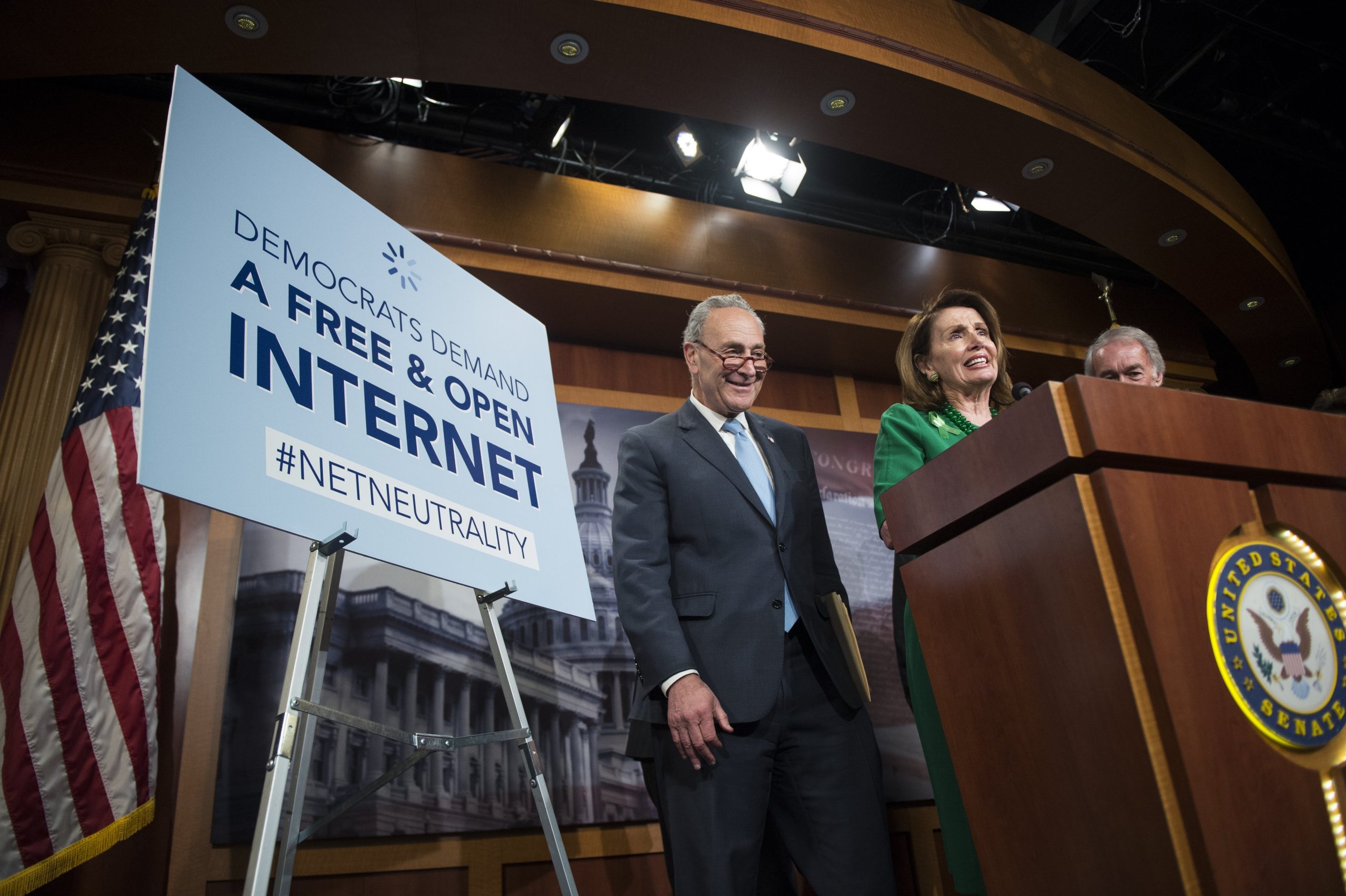 Senate Minority Leader Sen. Charles Schumer, D-NY, and House Minority Leader Nancy Pelosi smile during a press conference following the vote that would help stop the Federal Communications Commission's effort to reverse Obama-era regulations on net neutrality May 16, 2018.