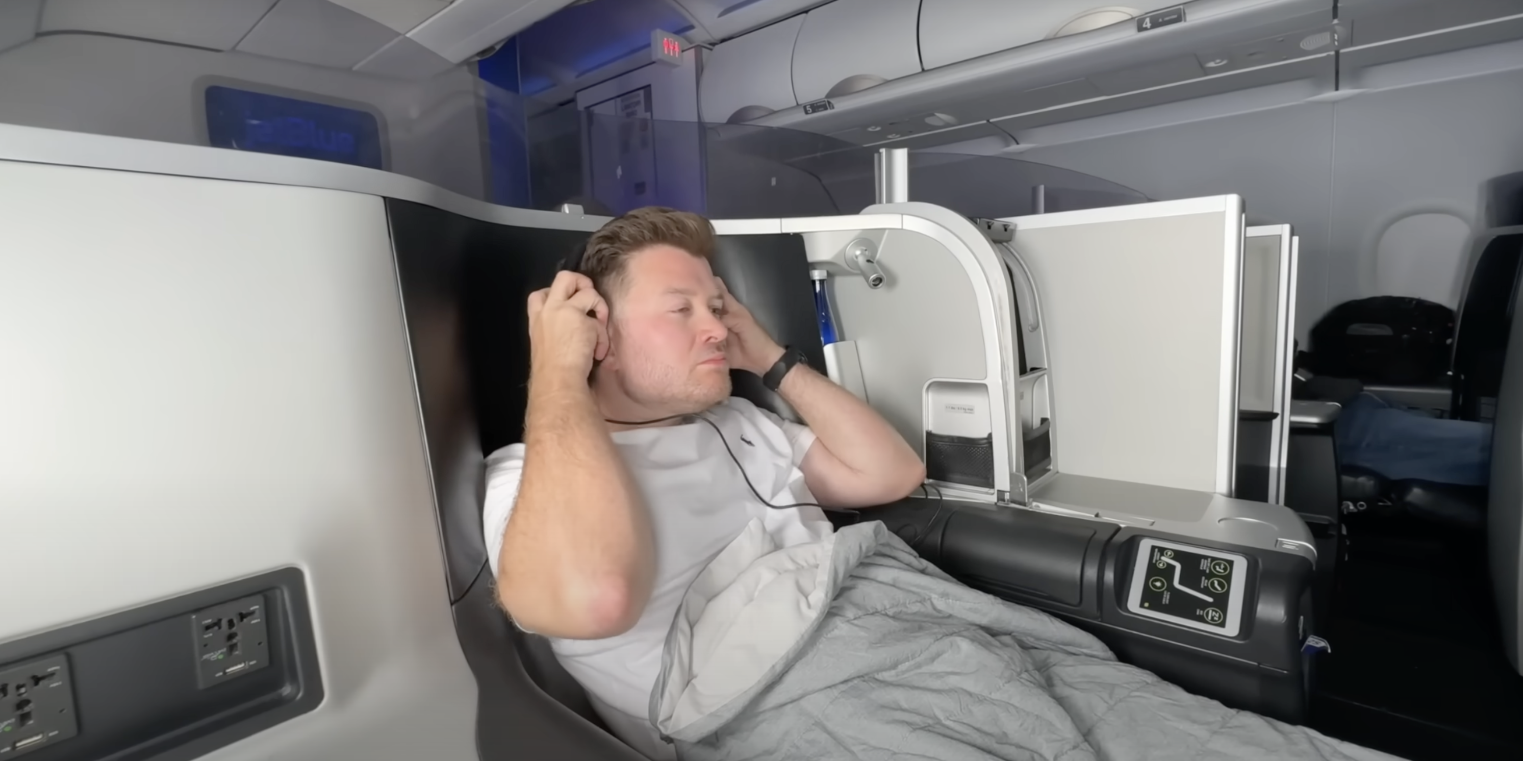 A man sitting in first class on an airplane