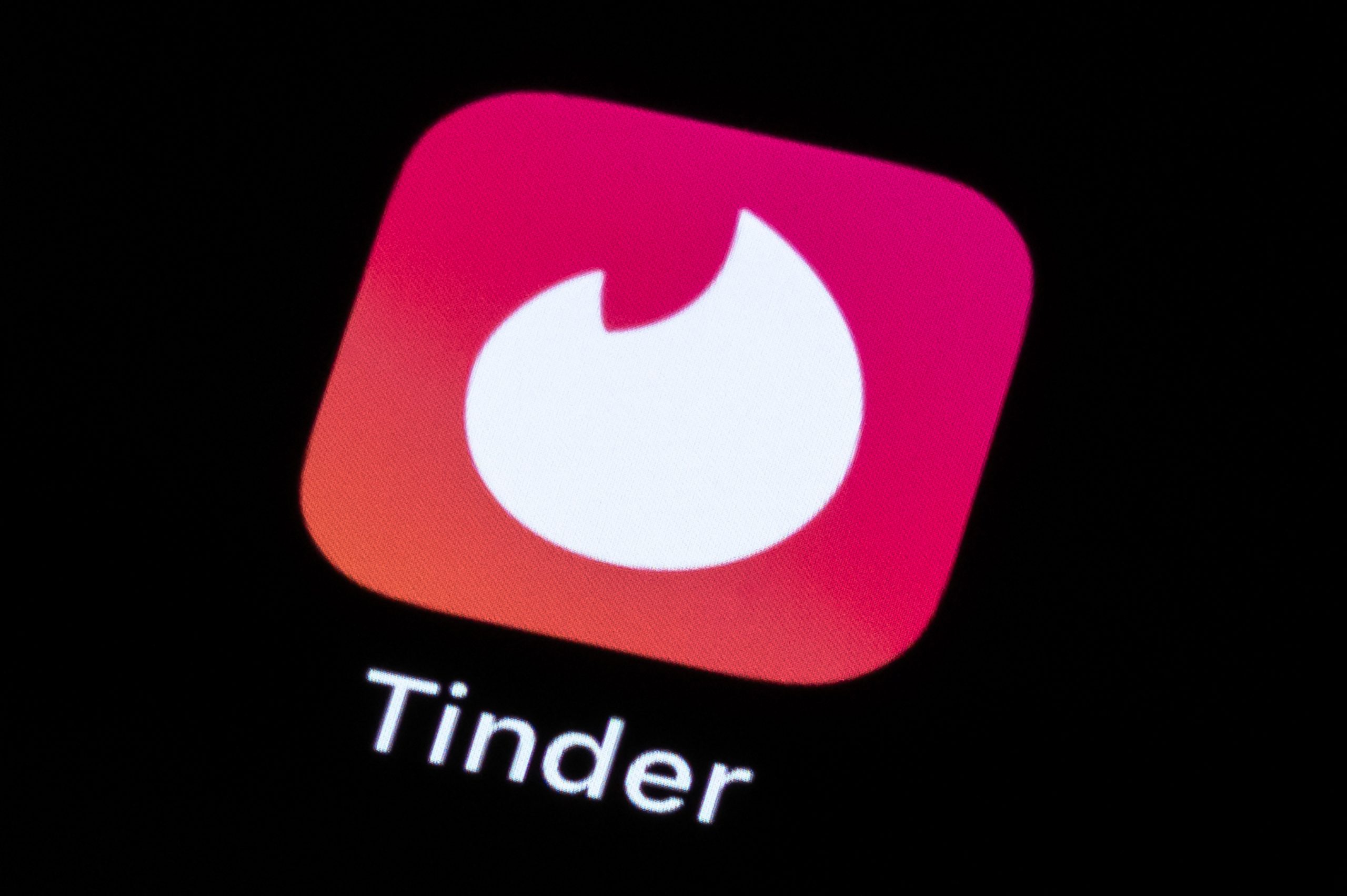 tinder logo displayed on smart phone