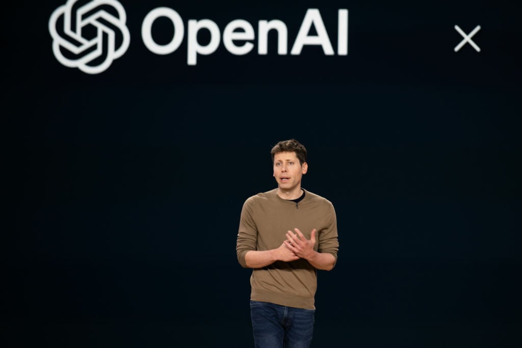 OpenAI CEO Sam Altman on stage at an event