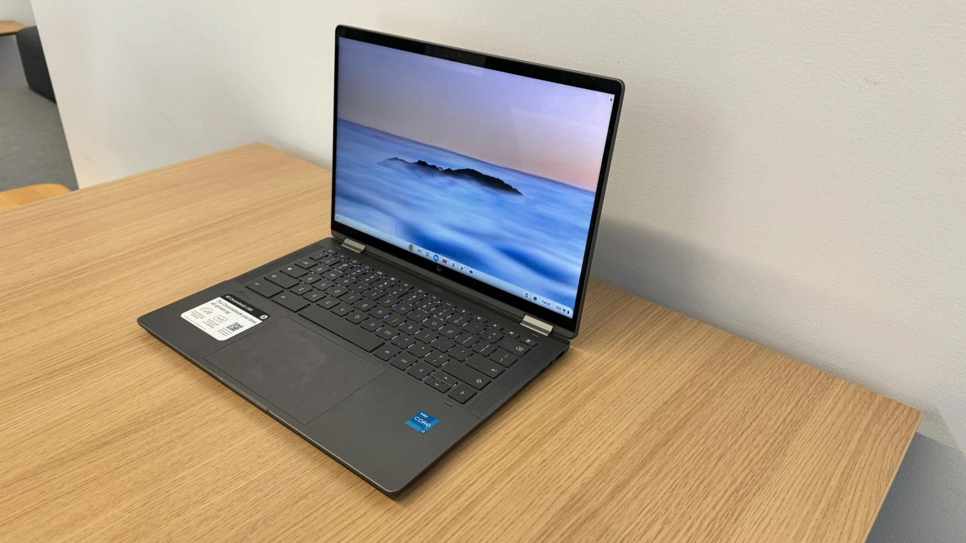 An HP Chromebook sitting on a wooden table