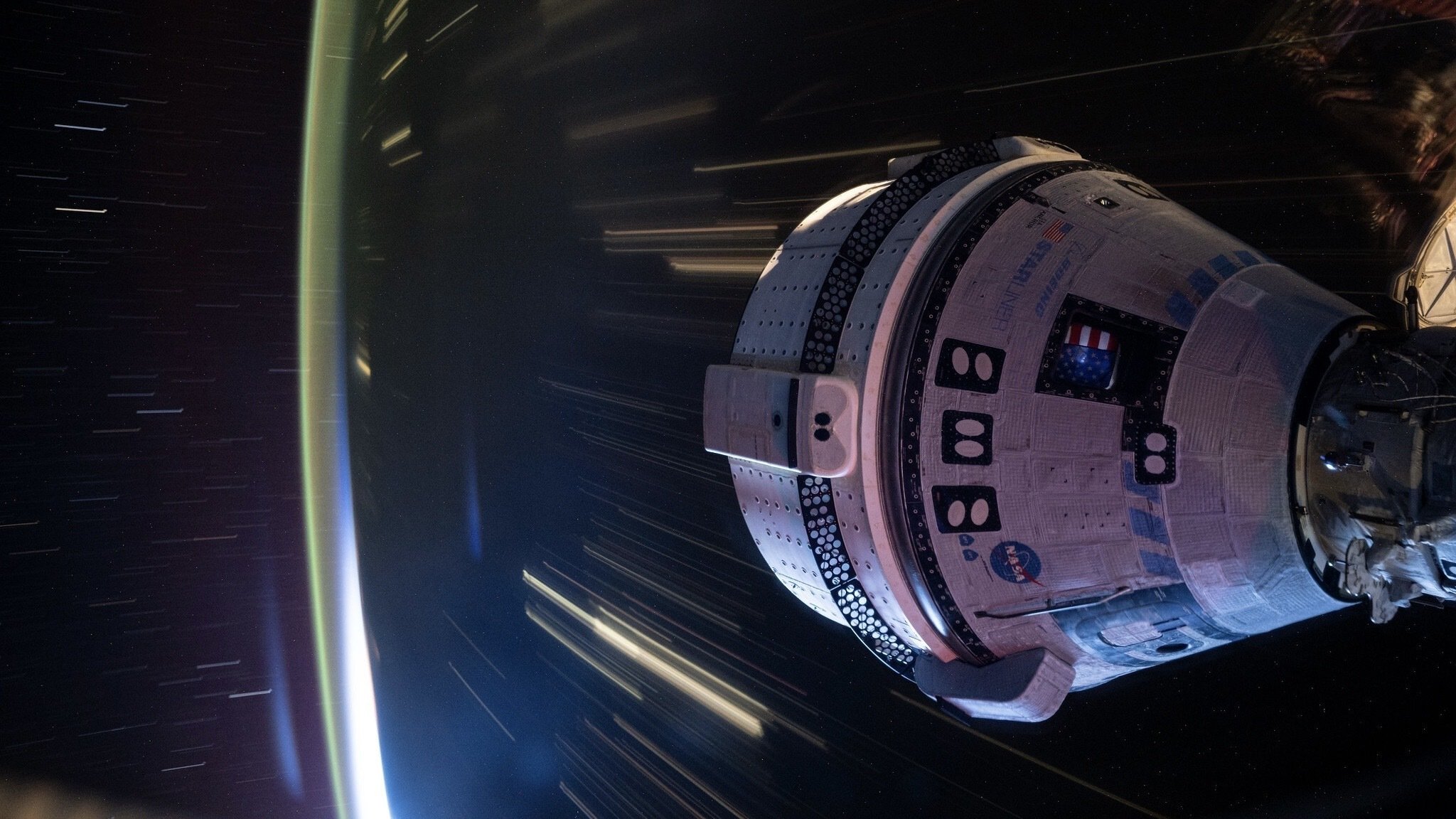 Boeing Starliner flying over Earth while docket at ISS