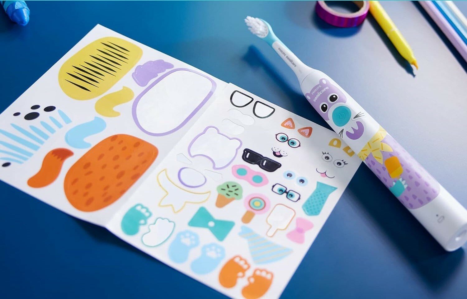 the philips sonicare toothbrush for kids with pet design stickers lays on a surface