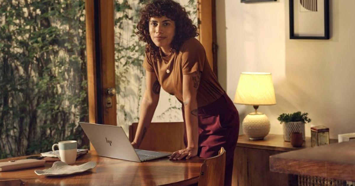 Woman standing at a table with the omnibookx