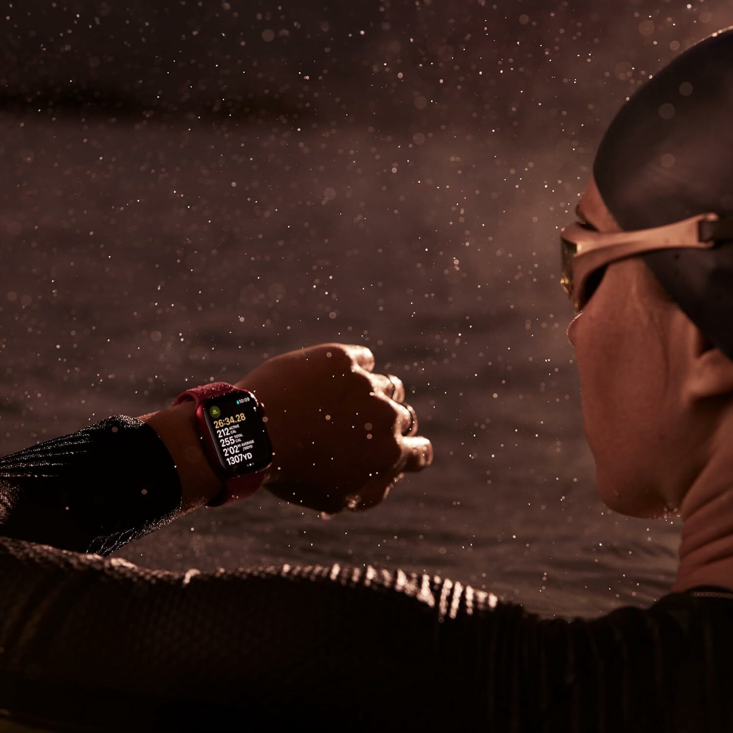 A swimmer checks data on an Apple Watch