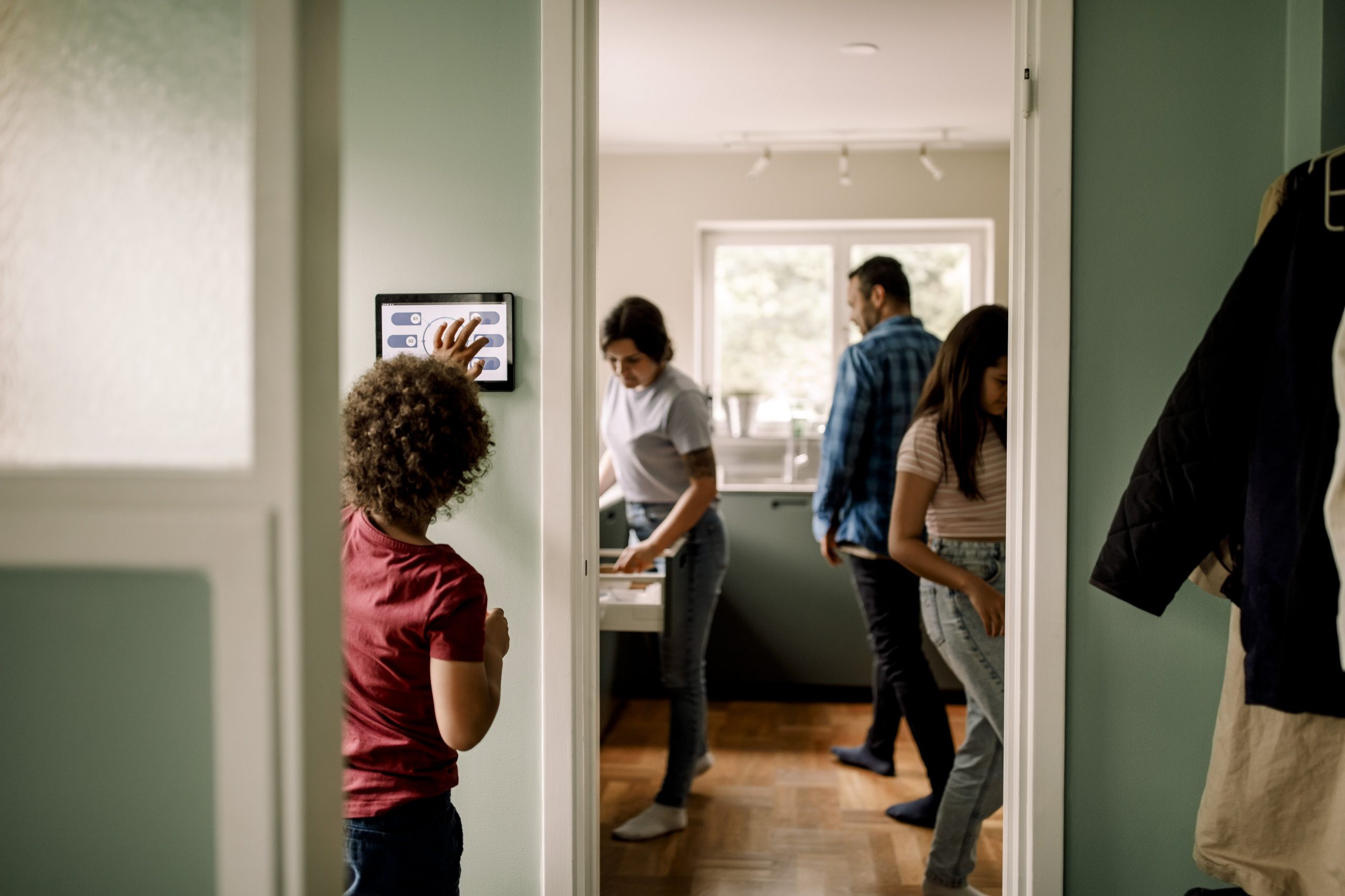 a family inside of their home uses smart home devices