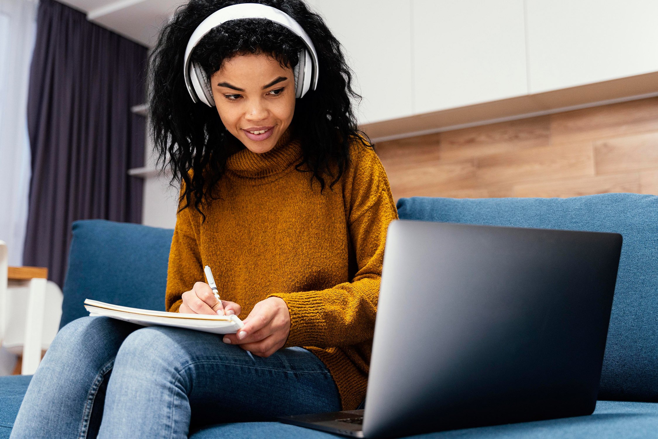 young woman taking online class with laptop