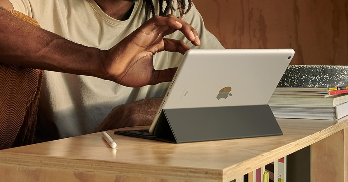 man using apple ipad 9th gen on a desk