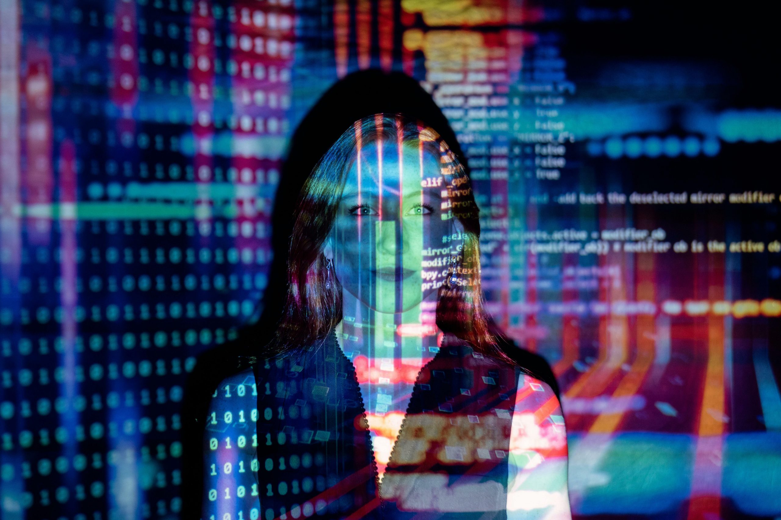 bright lights and computer code projected onto woman