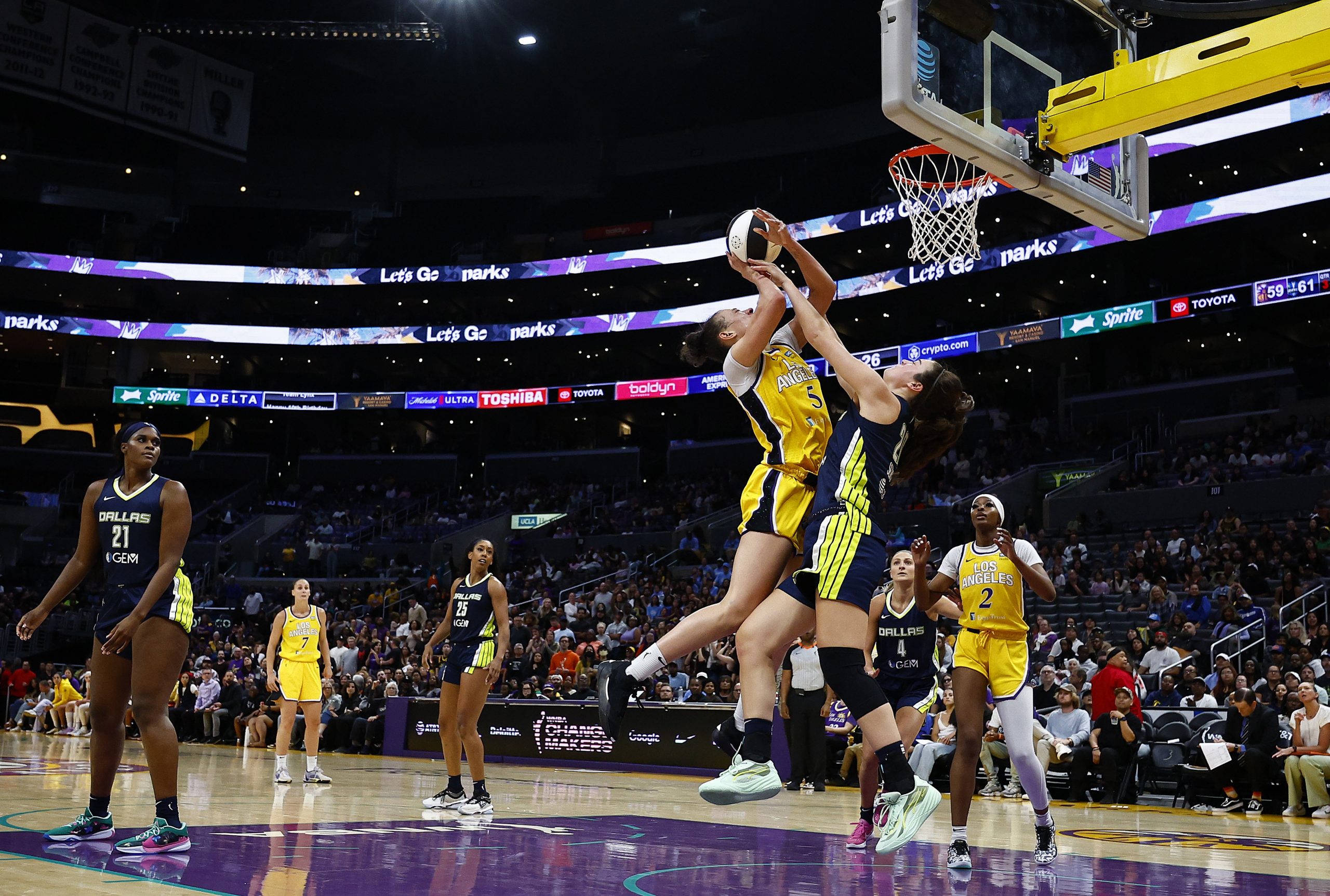 : Dearica Hamby #5 of the Los Angeles Sparks is fouled by Maddy Siegrist #20 of the Dallas Wings