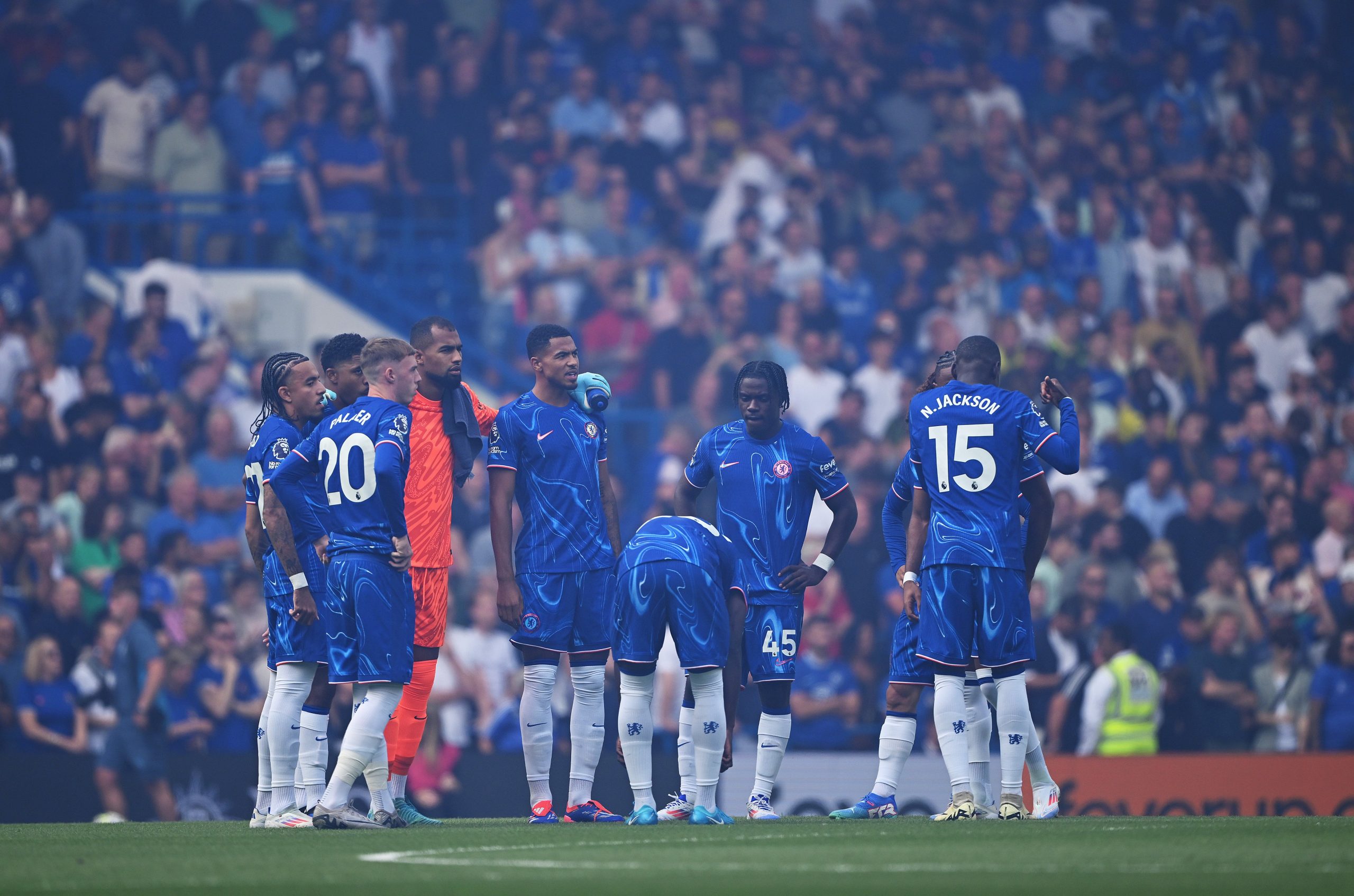 Players of Chelsea prepare to enter a huddle