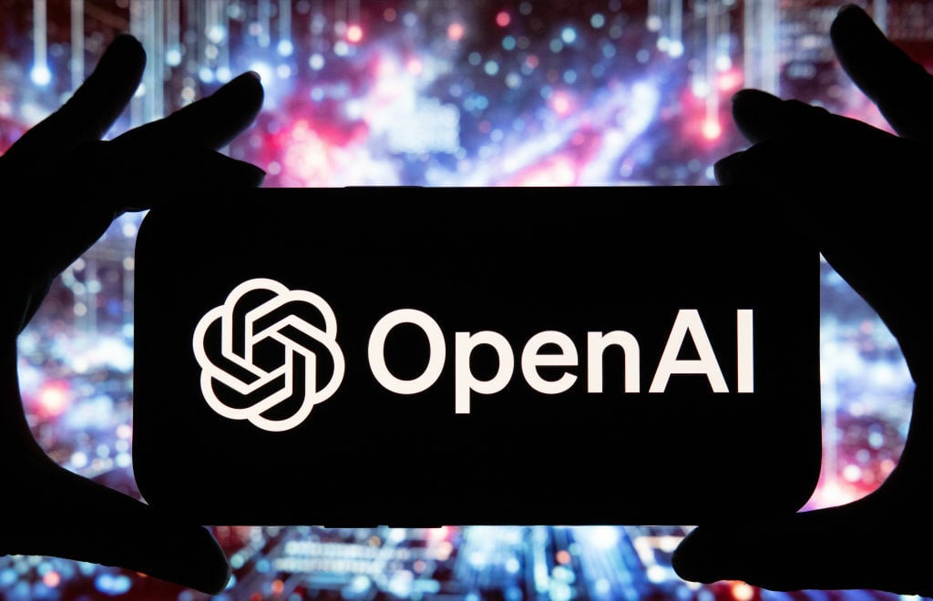 The OpenAI logo on a smartphone against the backdrop of colorful light flares