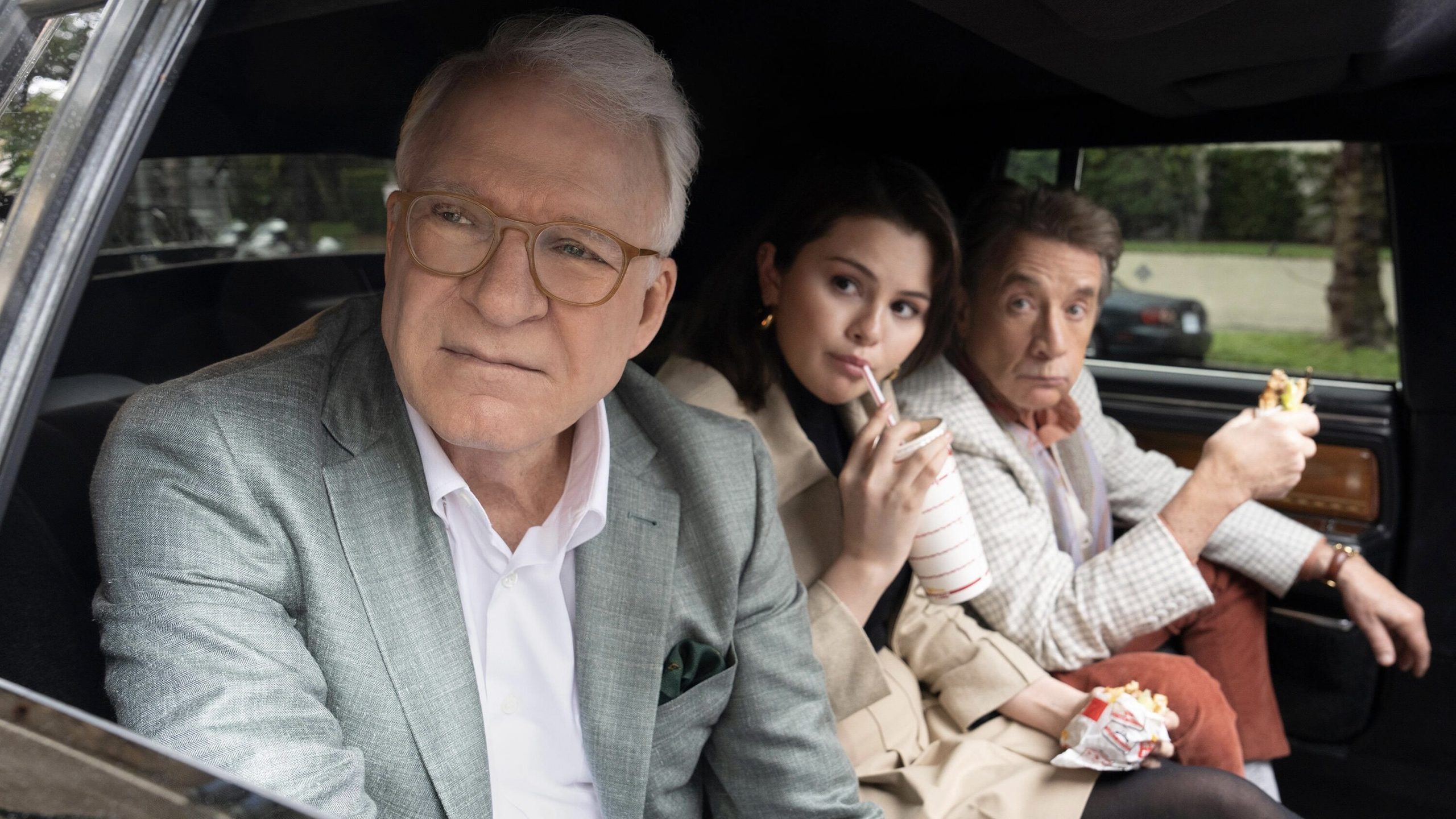 Charles, Mabel, and Oliver in the backseat of a car.