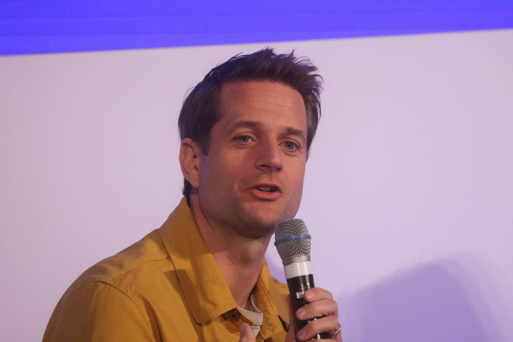 Sebastian Siemiatkowski, CEO of Klarna speaking on a microphone at an event