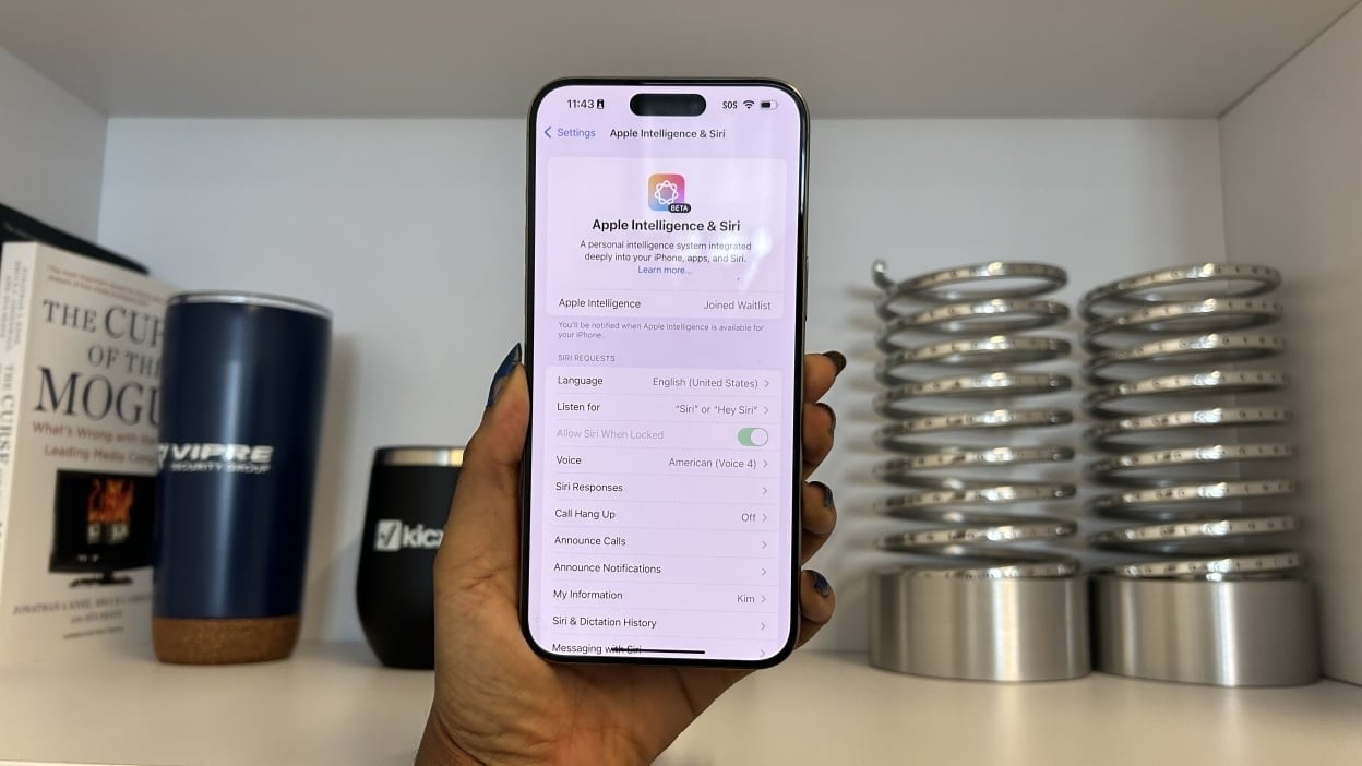 Woman holding the iPhone 15 Pro Max with the Apple Intelligence app in Settings