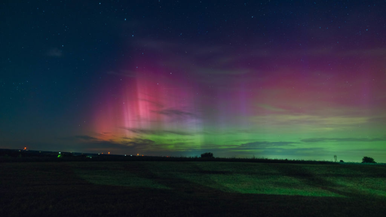 Wisconsin's night sky is glowing with the Northern Lights, as a geomagnetic storm is bringing vibrant pink and green colors, stealing the spotlight from the Perseus meteor shower.