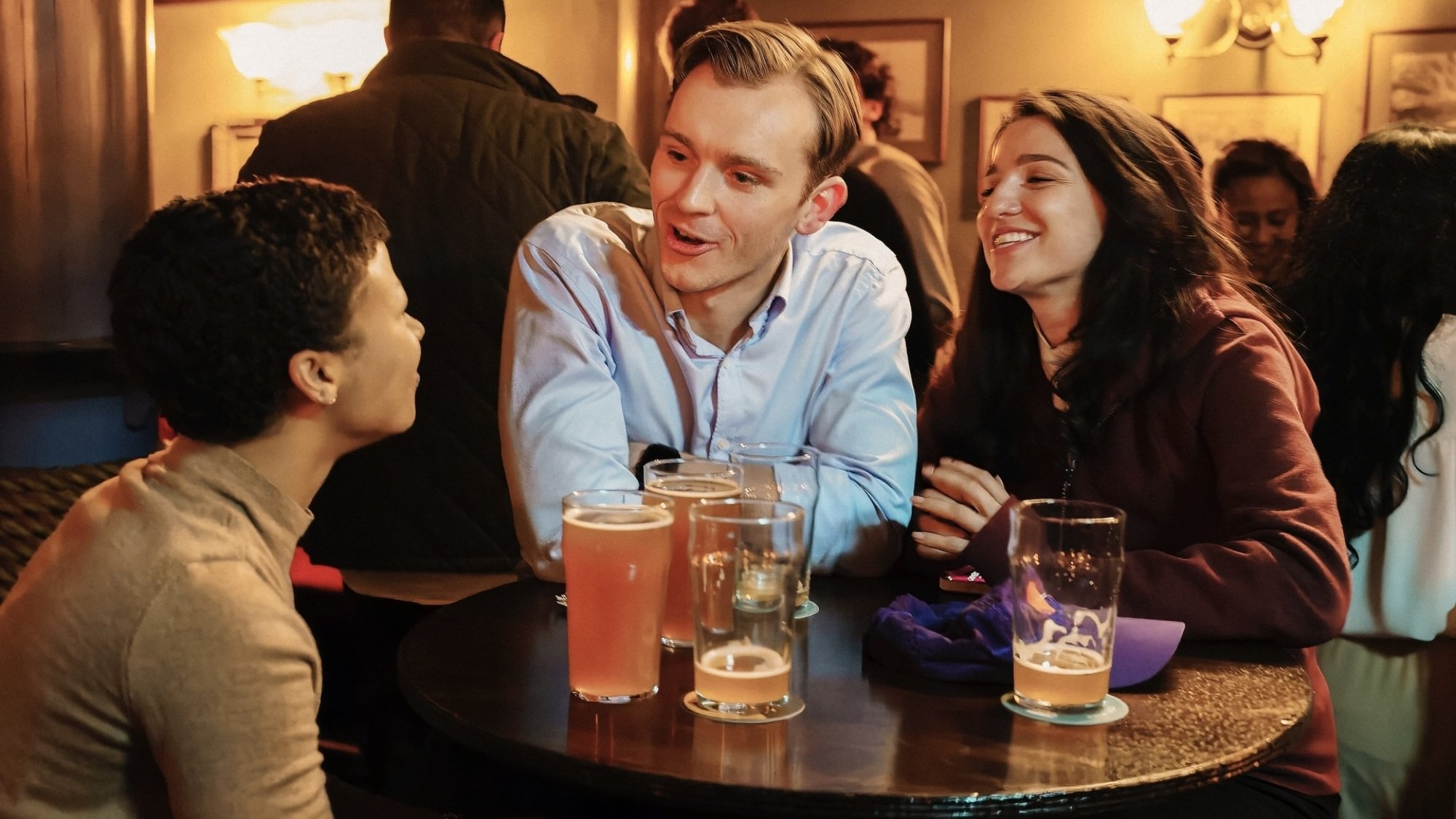 Harper Stern, Yasmin Kara-Hanani, and Robert Spearing having drinks at a pub.