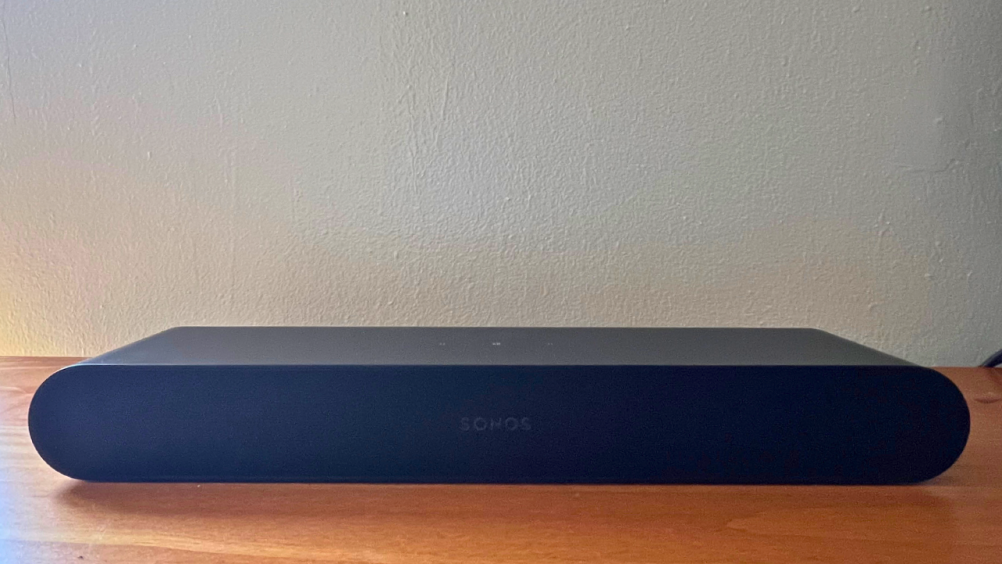 black sonos ray soundbar on wooden table