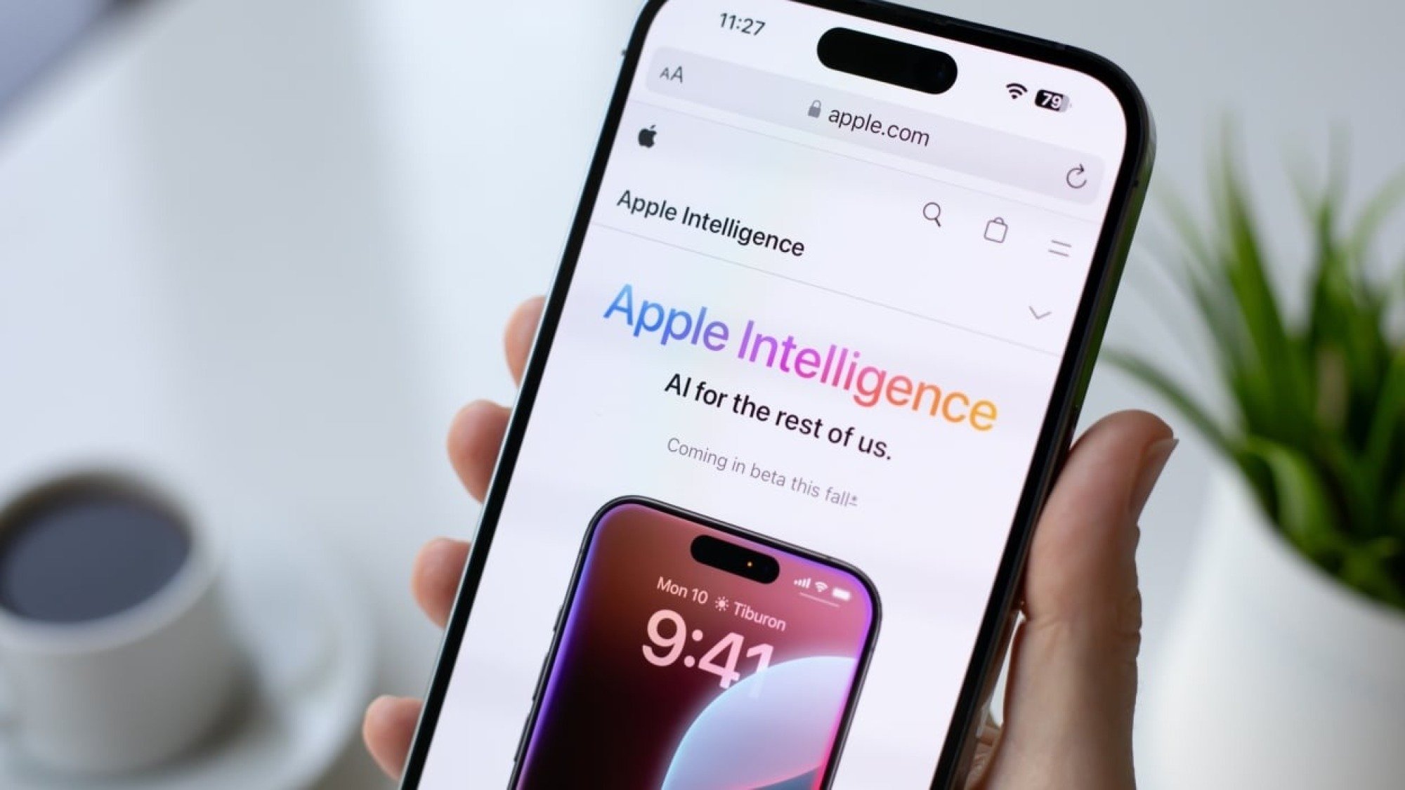 Someone holding an iPhone with an Apple Intelligence article