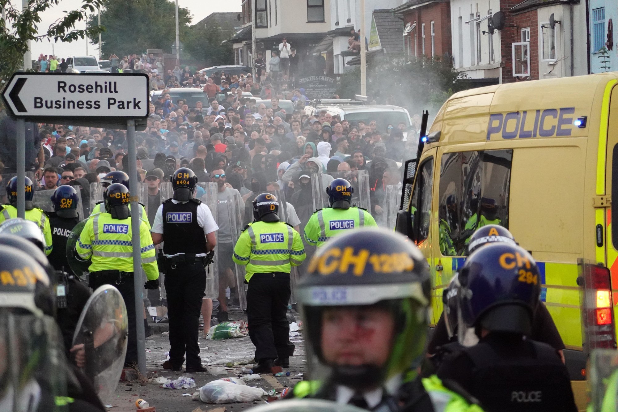 Riot police face a crowd of rioters on July 30, 2024 in Southport, England.