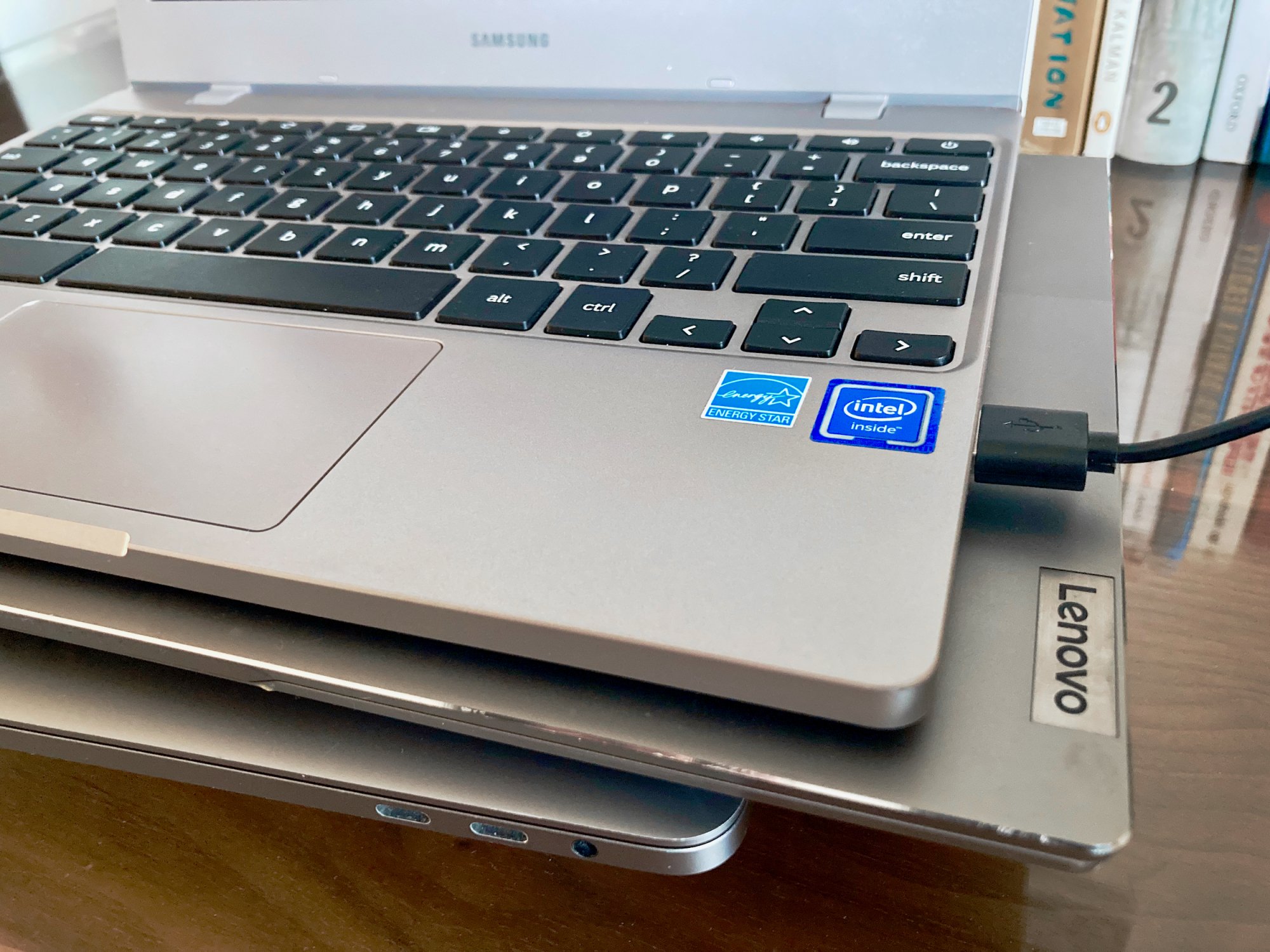 close-up of a pile of chromebooks with Intel and Lenovo branding visible