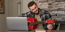 Person learning guitar