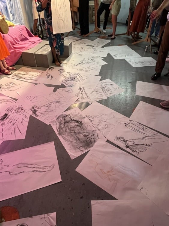 A series of life drawings on a floor, the result of various creative collaborations.