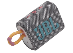 A small rectangular speaker with a grey body and mustard, pink, and blue accents.