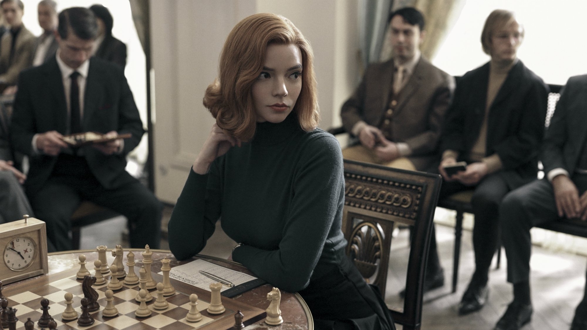 A woman plays chess in a competition. 