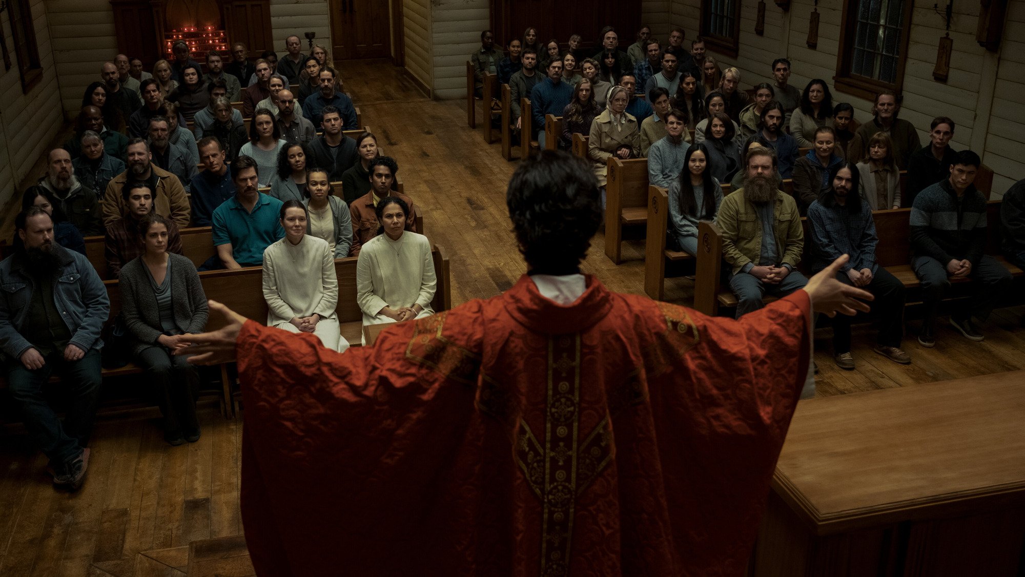 A priest leads a sermon in a church. 