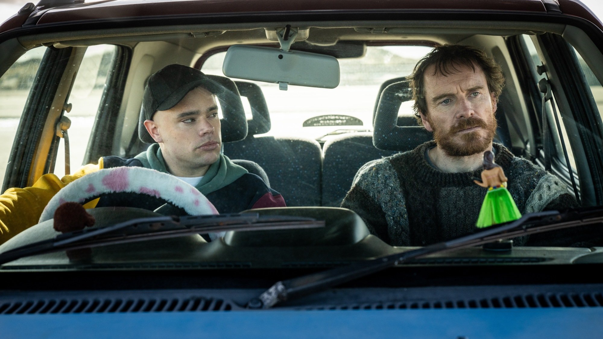 Naoise Ó Cairealláin as Móglaí Bap or Naoise and Michael Fassbender as Arló Ó Cairealláin in "Kneecap"