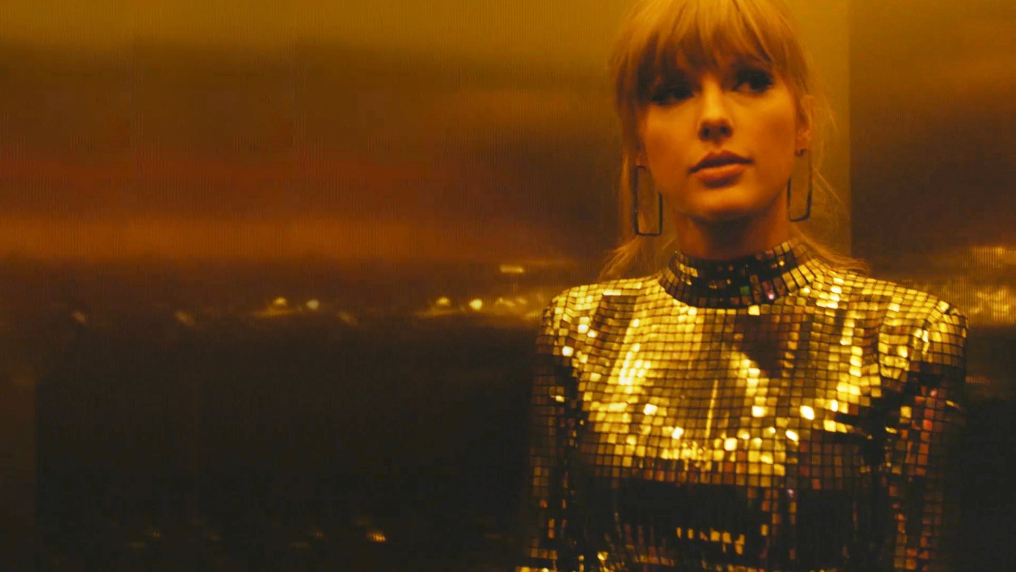 Taylor Swift wears a gold outfit