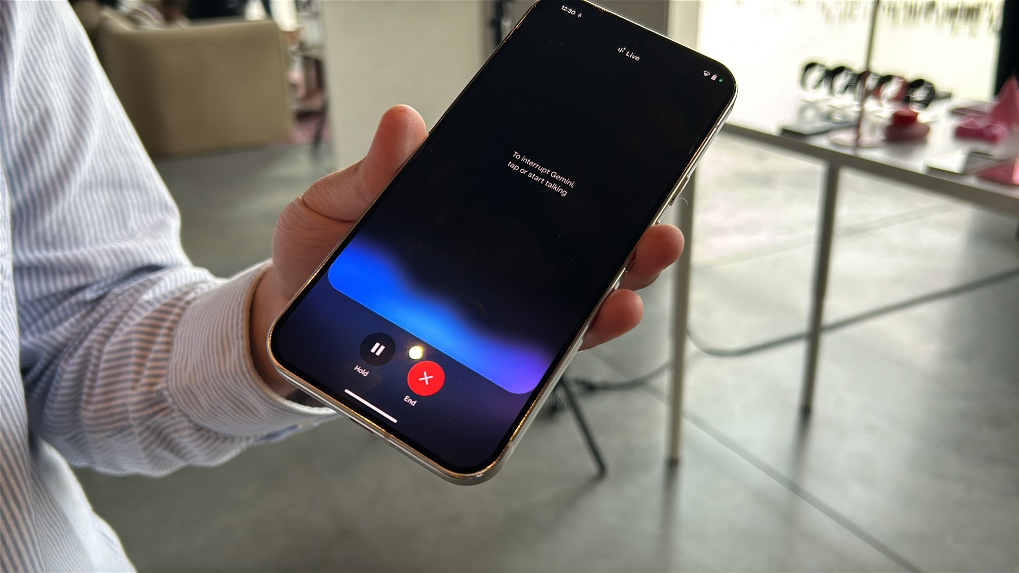 Man holding Pixel 9 series phone with Gemini Live