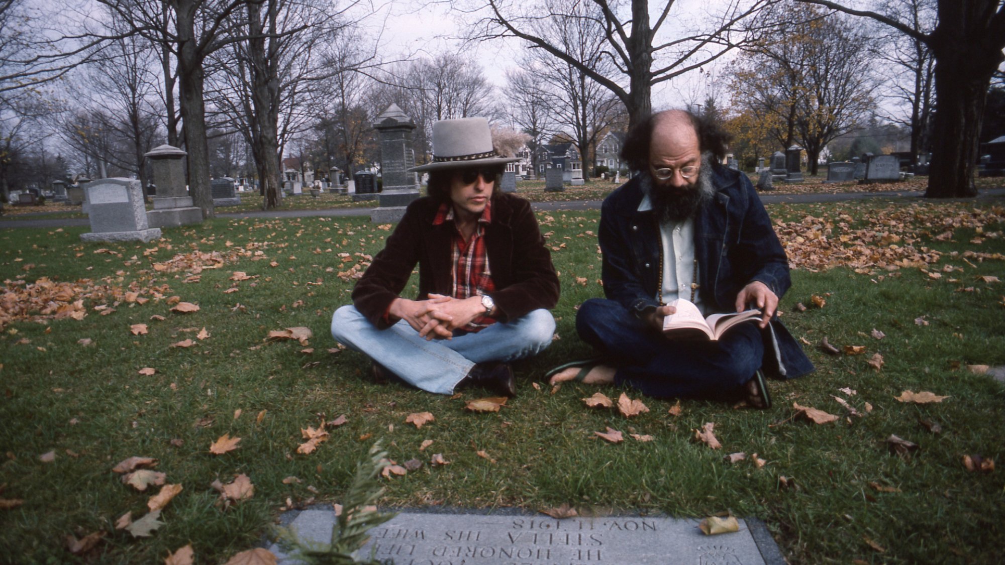 Bob Dylan and Allen Ginsberg visit Jack Kerouac's grave.