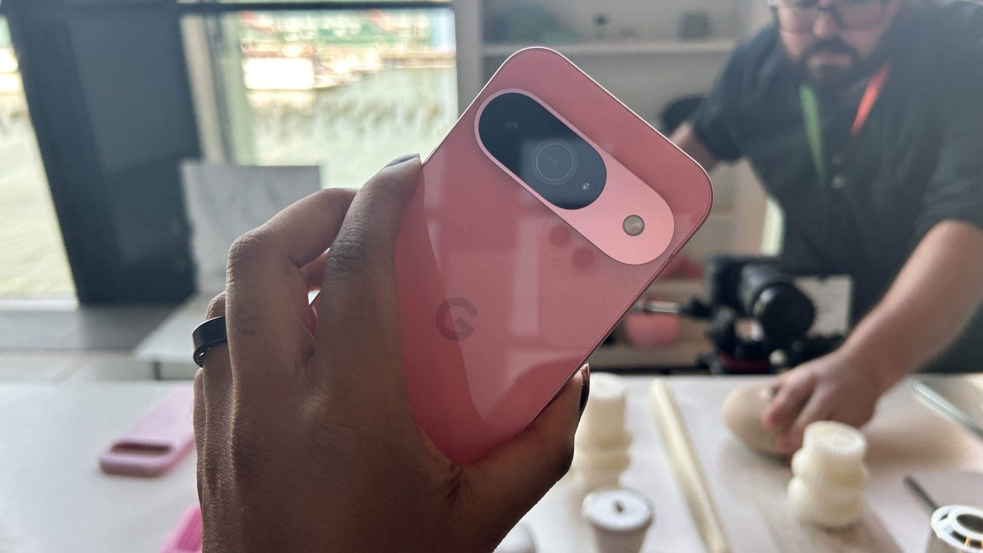 Google Pixel 9 in hand showing camera lens