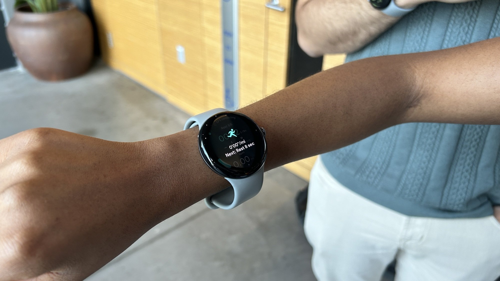 Pixel Watch 3 on a woman's arm showing instructions for a timed running interval