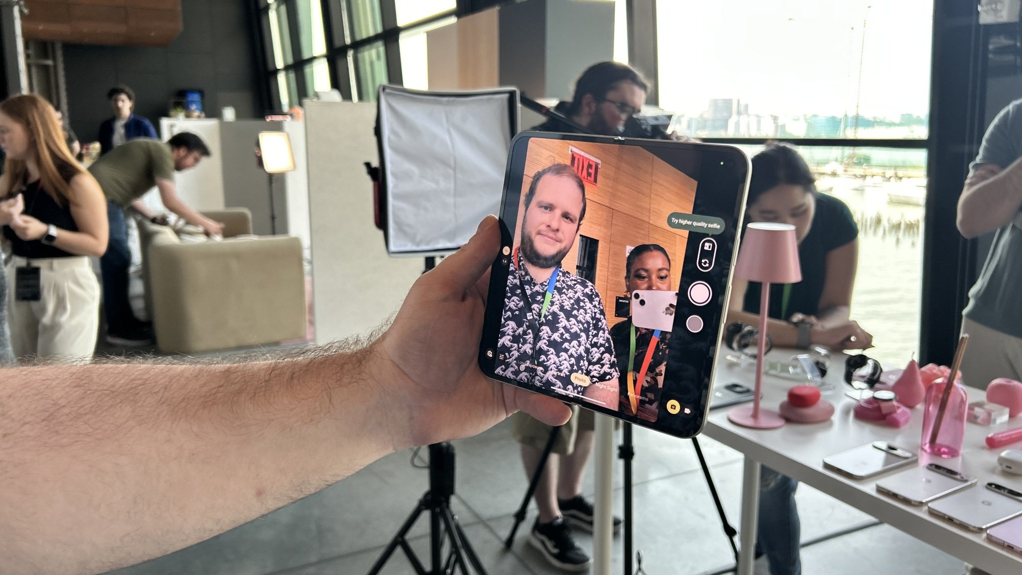 Google Pixel 9 Pro Fold in hand showcasing selfie camera on inner display