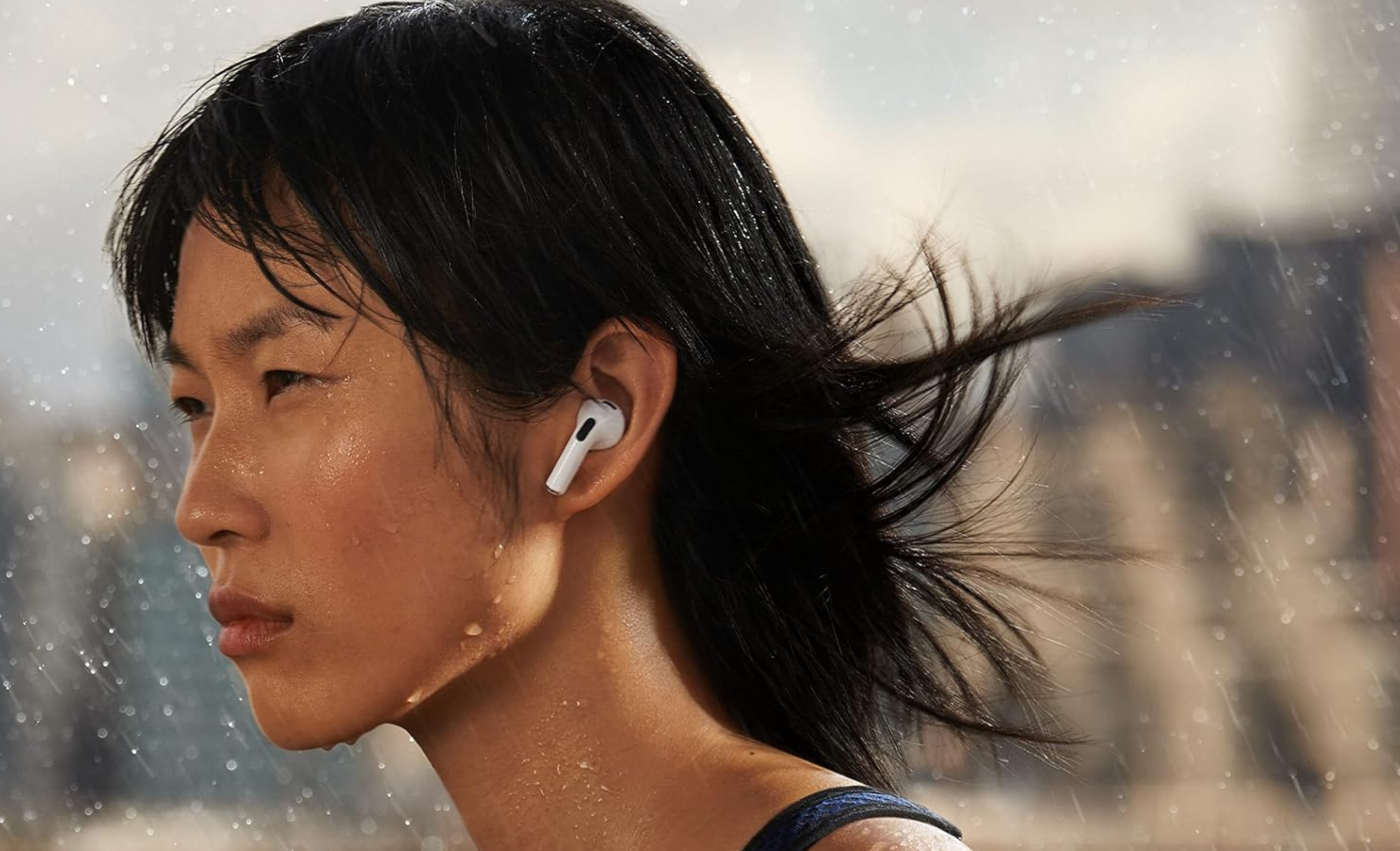 woman wearing apple airpods in the rain 