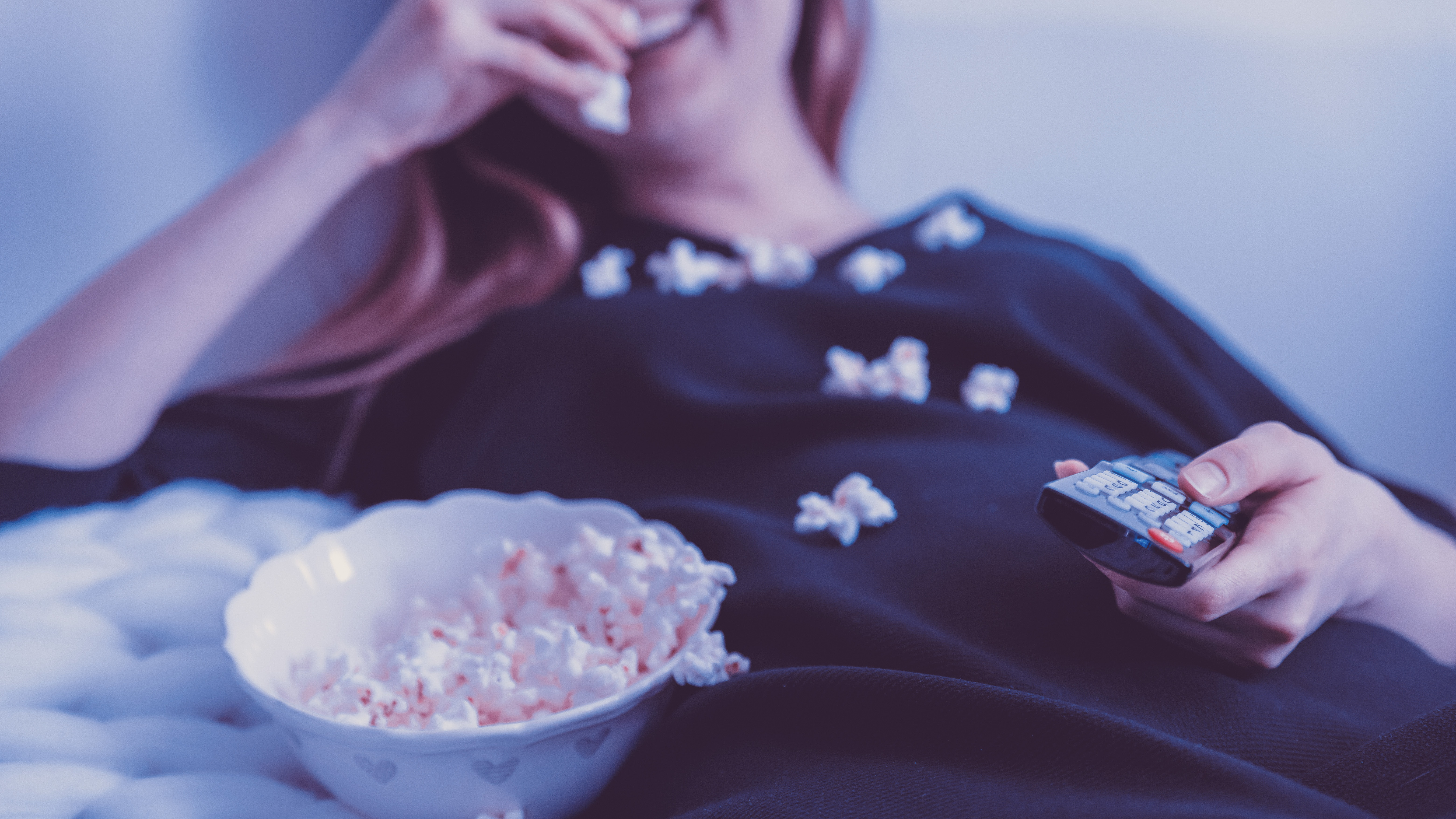 Person lying down with popcorn