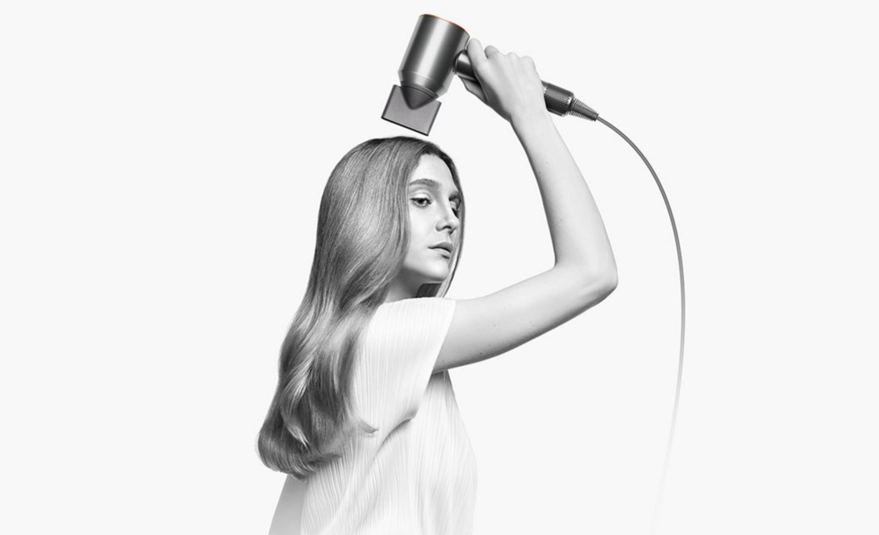 woman using the dyson supersonic hair dryer 