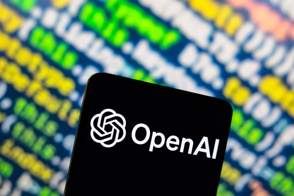 the OpenAI logo is displayed on a smartphone screen.